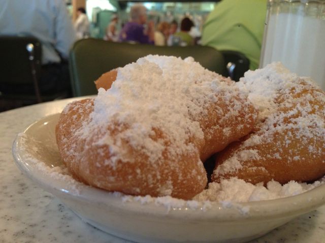 Cafe Du Monde's beignets sitting on a table waiting to be eaten