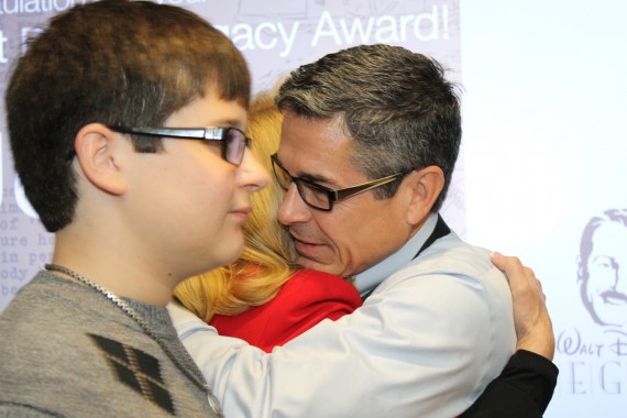 Husband and wife hugging at awards ceremony
