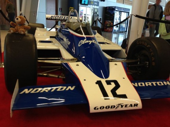 Teddy bear sitting on Indy race care
