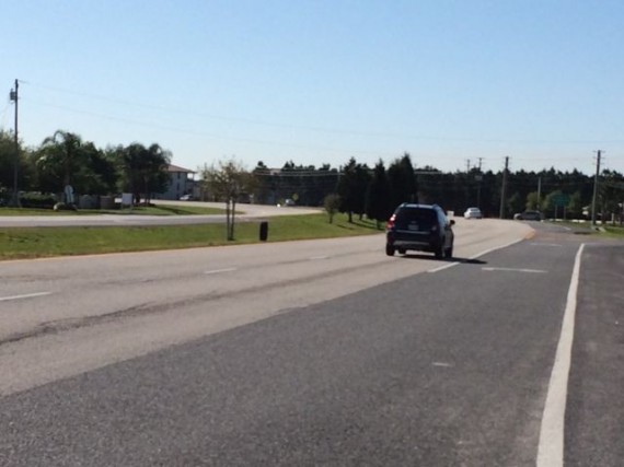 Loose Jeep tire rolling down highway