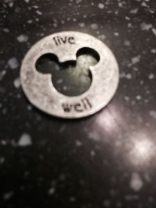 Live well coin shaped like Mickey Mouse