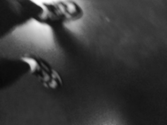 Black and white photo of runners feet in the dark