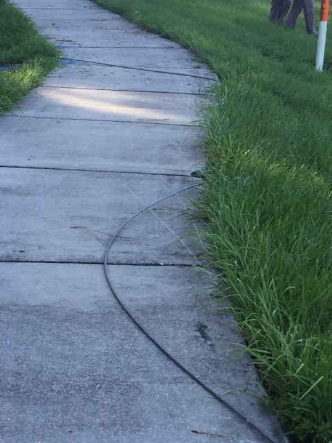 Live electric wire on sidewalk