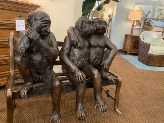 Three monkey sculptures ion a bench