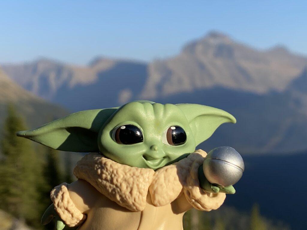 Baby Yoda toy in mountains