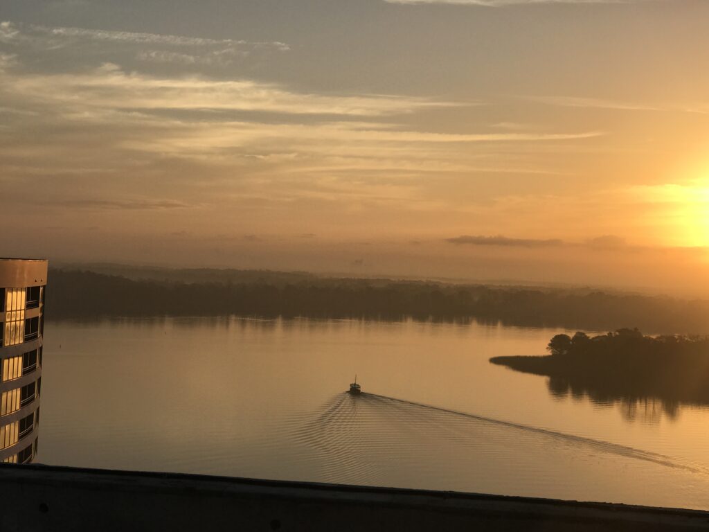 sunrise lone boat on a lake