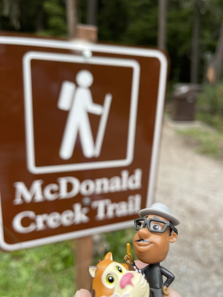 Pixar Soul toys by hiking trail sign