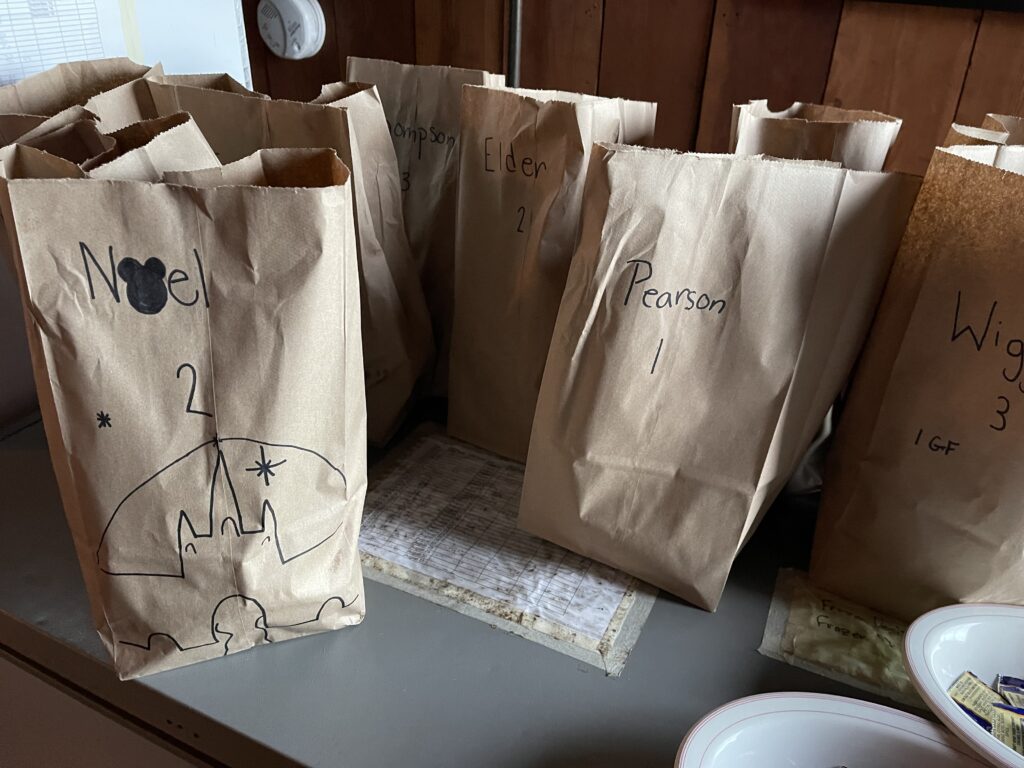 Group of paper bag lunches on table