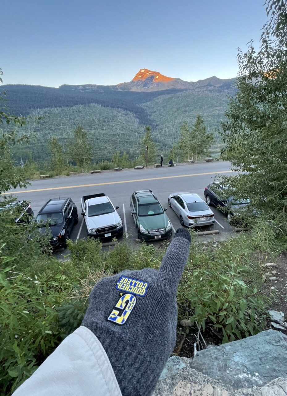 Person pointing at a parked car