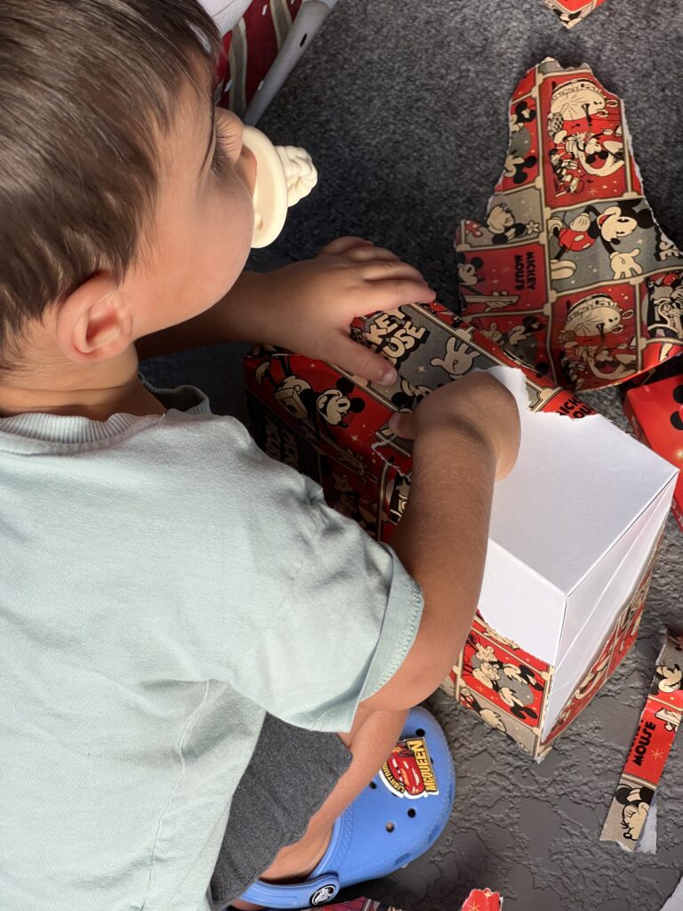 toddler opening Christmas present