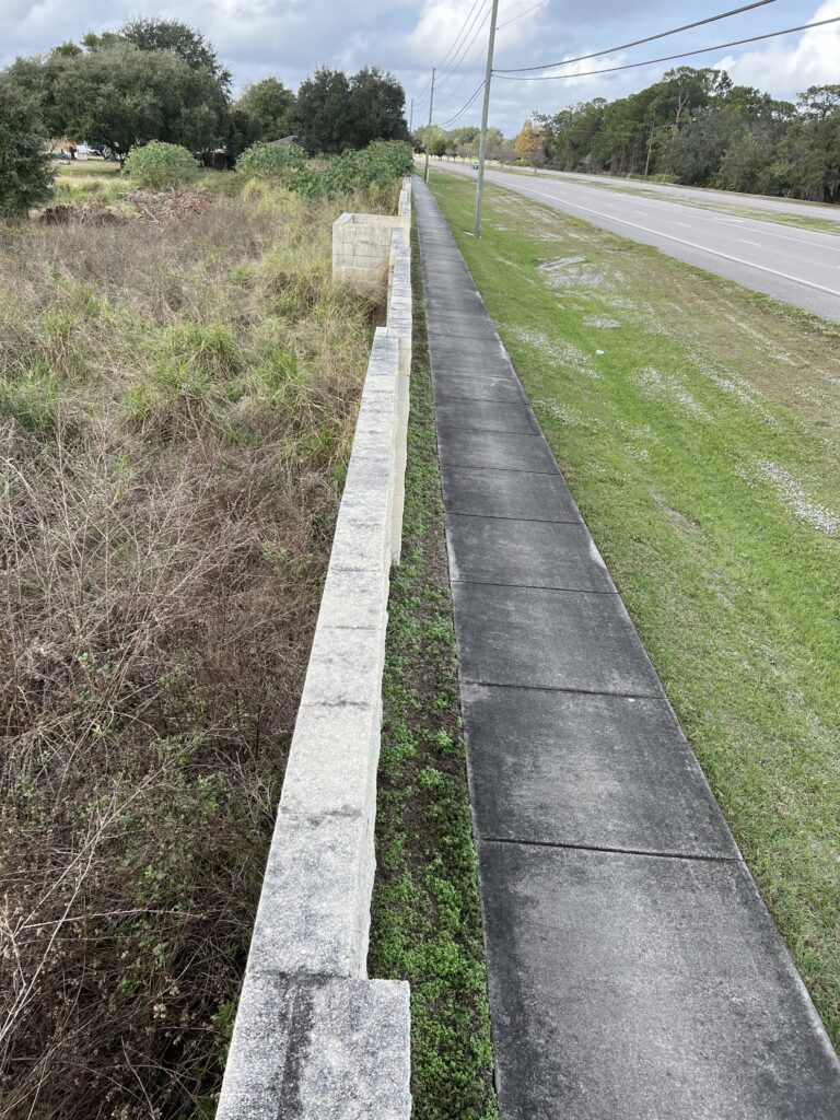 sidewalk and wall next to highway
