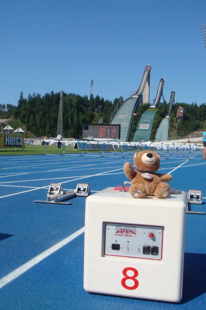 Teddy Bear on a track and field starting line