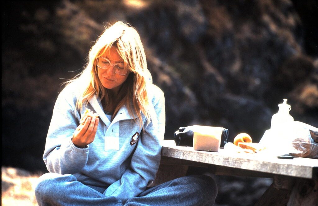 woman eating at picnic table