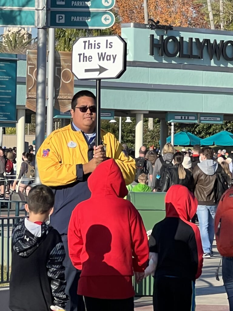 disney cast member holding sign