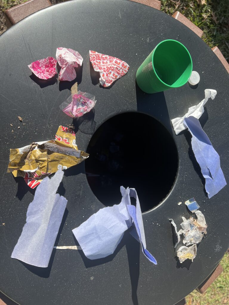 Trash can with trash on top